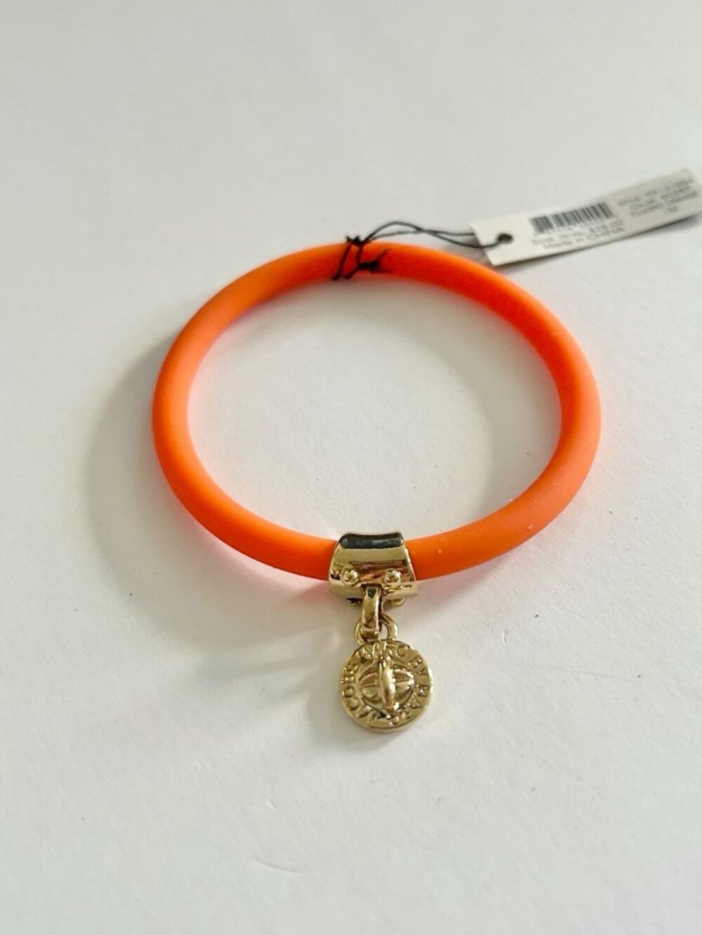 Marc by Marc Jacobs orange silicone bracelet with gold tone turnlock brand charm